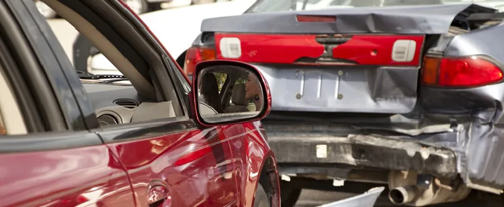 A rear-end accident scene, where there are car parts scattered