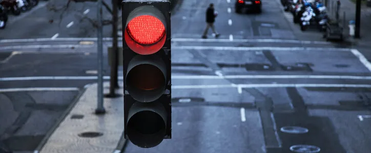 Red light hanging above a paved street in the city