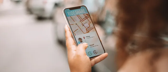 Person using a rideshare app waits for her ride to arrive