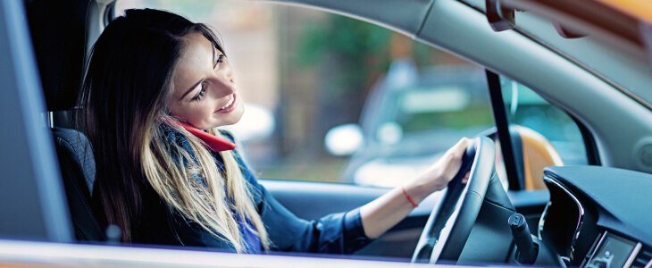 A woman is on the phone while driving