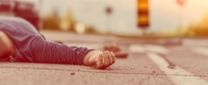 A man lays on a road