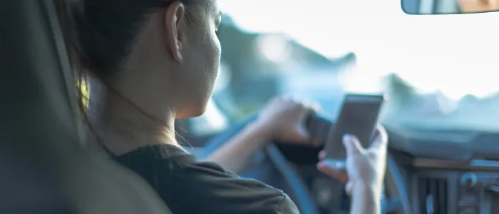 A woman texting and driving