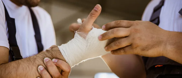 A person with bandages around his arm from an injury